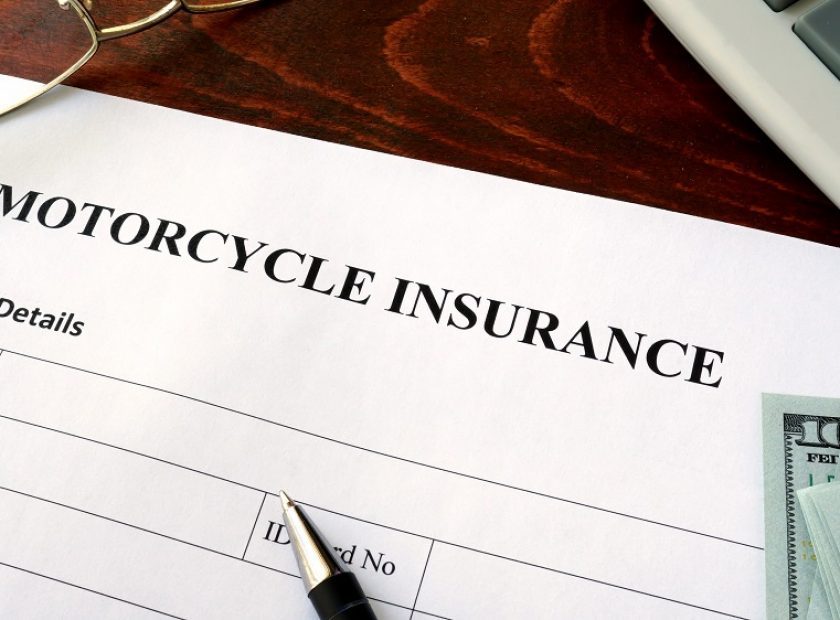 Motorcycle,Insurance,Form,And,Dollars,On,The,Table.